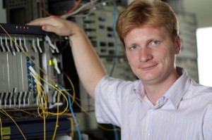 The telecom engineer poses on a multiplexer background